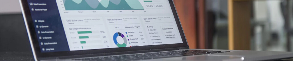 This image shows a laptop screen displaying analytical data, charts, and graphs.
